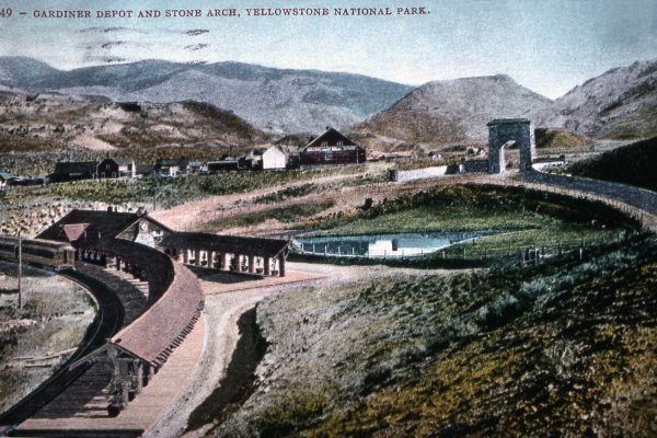F.J. Haynes Postcard, undated. Roosevelt Arch and train depot in Gardiner, MT