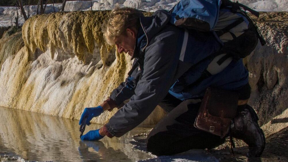 Professor Bruce Fouke continuing his research collecting samples at Mammoth Hot Springs